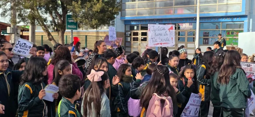 Los asistentes llegaron con pancartas para visibilizar su descontento y pedir que se reconsiderara la medida, destacando los años de servicio y el estrecho vínculo que la trabajadora mantenía con generaciones de estudiantes.